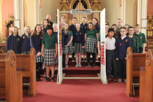 Students stand with their Holy Door for the Year of Mercy.