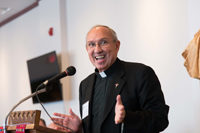 Fr. Barry Fischer speaking at a podium